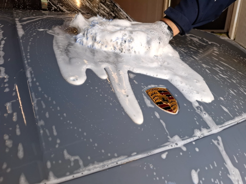 Standardno kontaktno pranje mikrofiber rukavicama uz Gyeon šampon na haubu sivog Porschea u LaserWash Rumenka